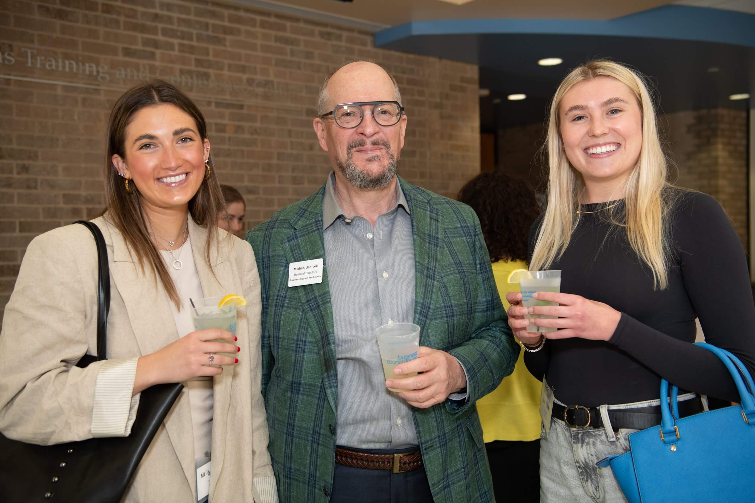 group of people with drinks posing at event