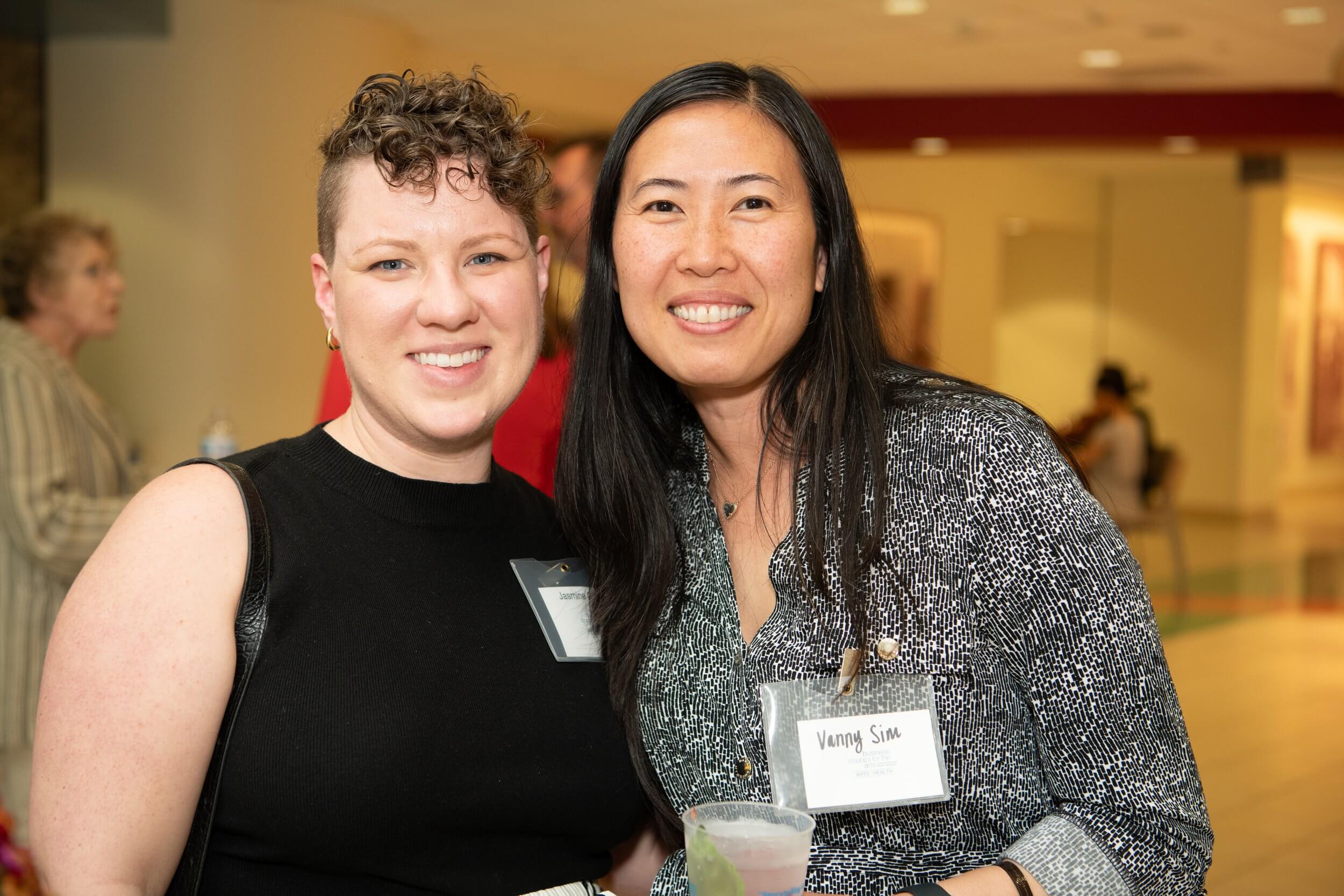 two women smiling at event