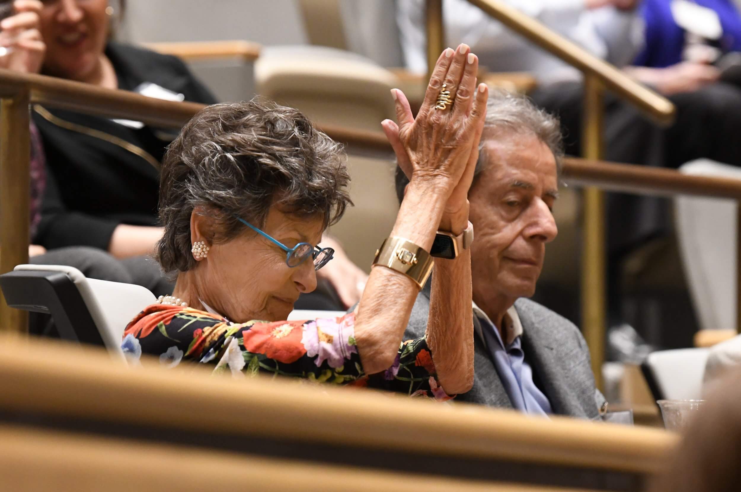 woman audience member with praise hands