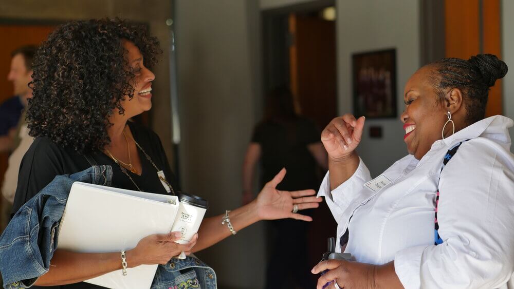 two women shaking hands