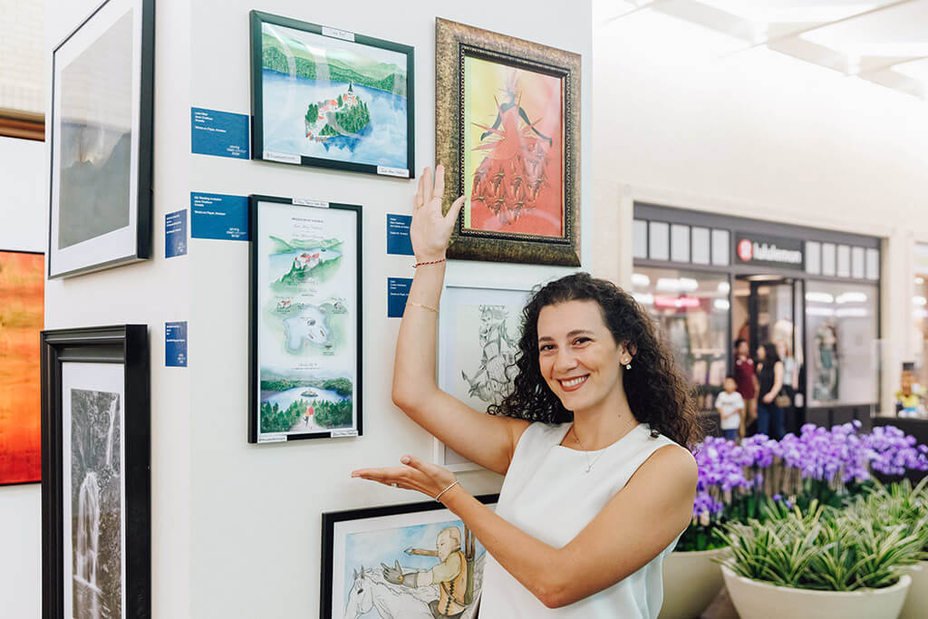 Woman posing with artwork