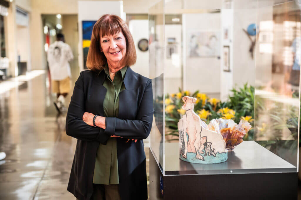 woman smiling by sculpture