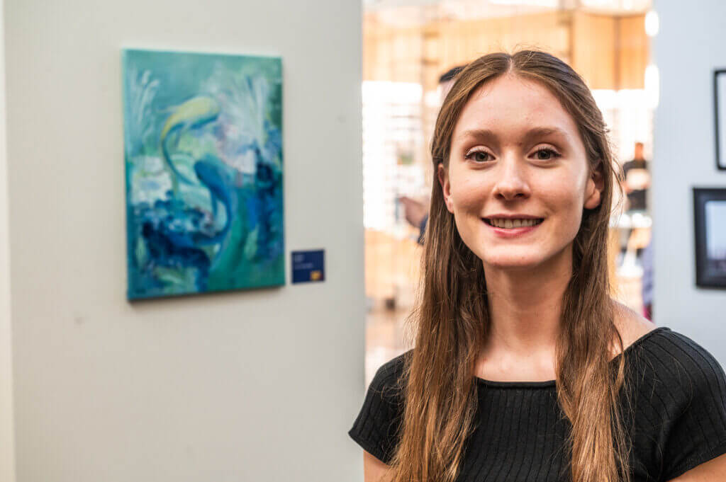 woman posing by art of water