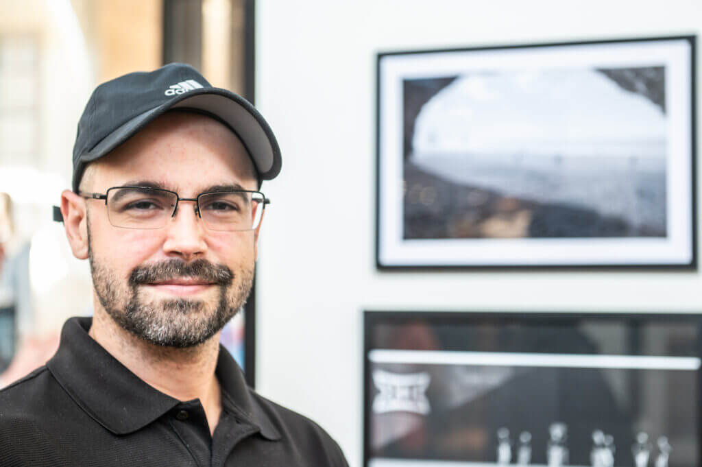 man in hat posing by art