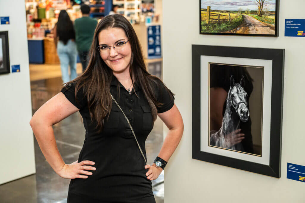 woman posing by art of horse