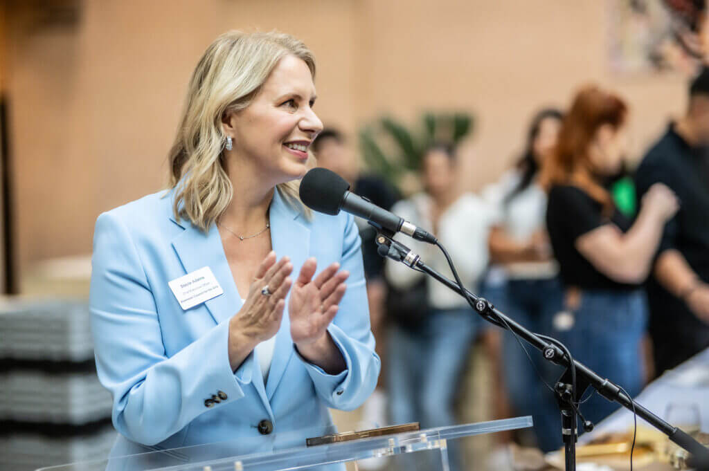 woman speaking into microphone smiling