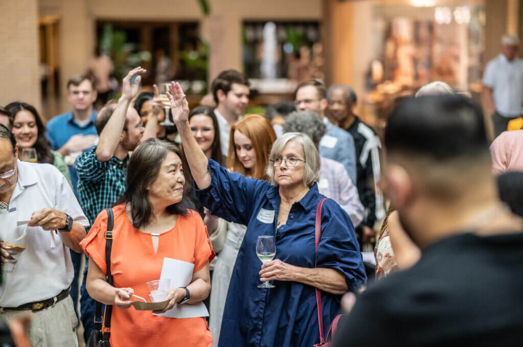 woman in group raising hand